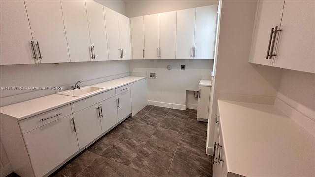 laundry area featuring cabinets, washer / clothes dryer, and sink