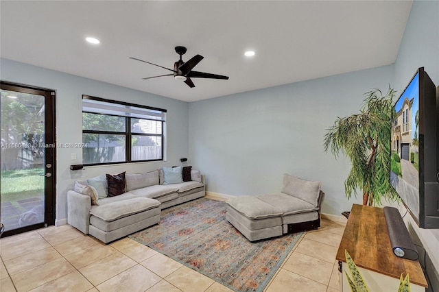 living room with ceiling fan and light tile patterned floors