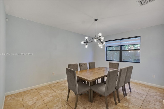 tiled dining space with a chandelier