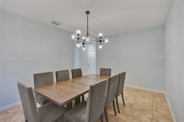 dining area featuring light tile patterned flooring and an inviting chandelier