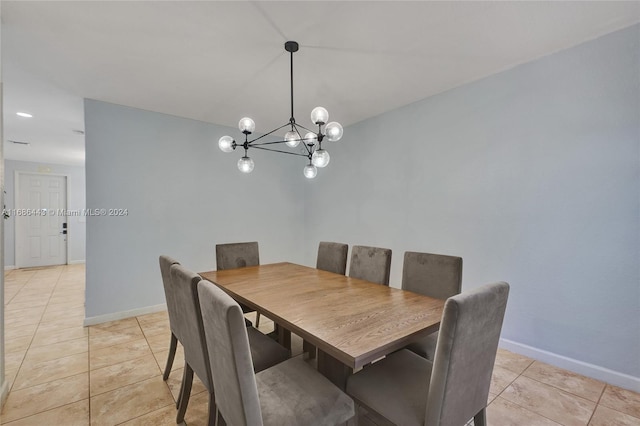 dining room with a chandelier and light tile patterned flooring