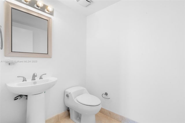 bathroom featuring sink, tile patterned floors, and toilet