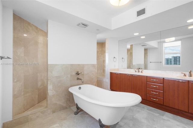 bathroom with vanity, tile walls, and plus walk in shower