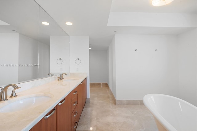 bathroom featuring vanity and a tub