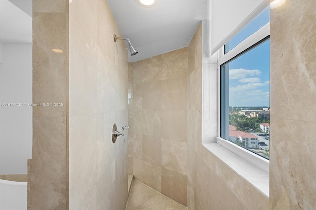 bathroom with a tile shower