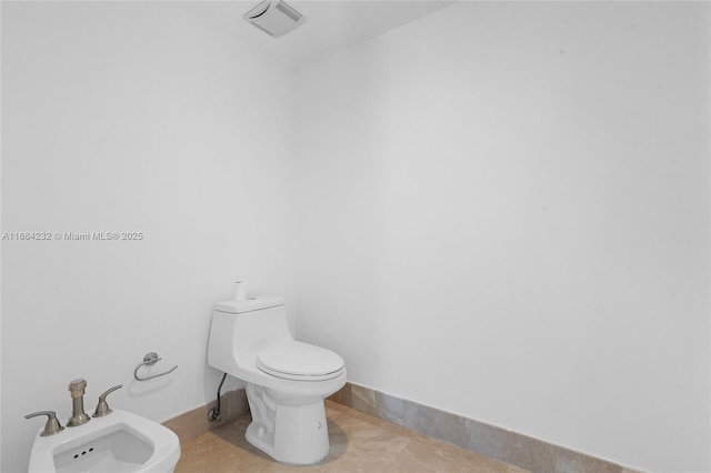 bathroom featuring a bidet and toilet