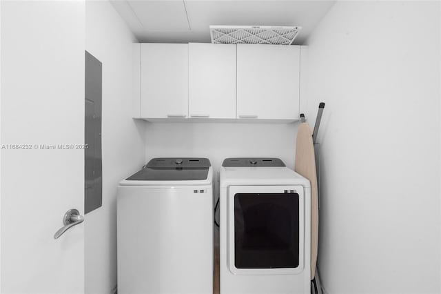 laundry room featuring cabinets and washer and dryer