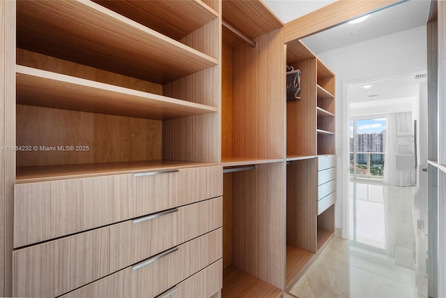 spacious closet featuring light tile patterned floors