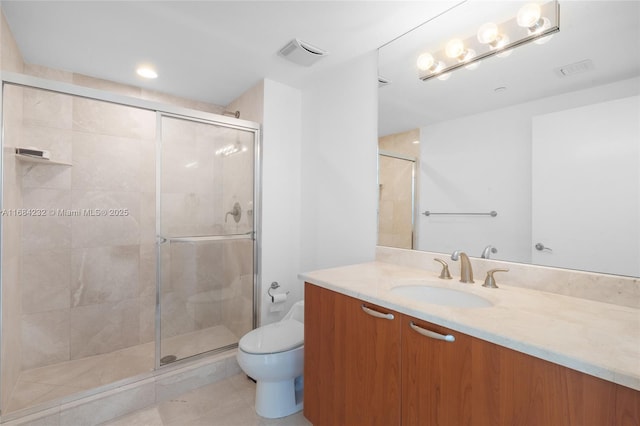 bathroom with vanity, tile patterned flooring, toilet, and walk in shower