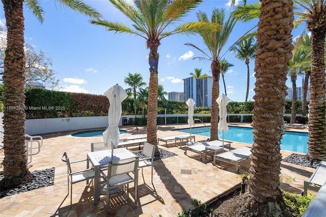 view of pool featuring a patio and a community hot tub