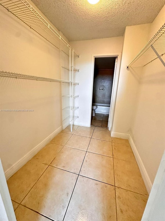 spacious closet featuring tile patterned floors