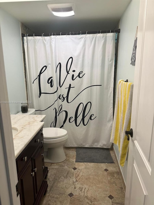 full bathroom with vanity, shower / bath combo with shower curtain, and toilet