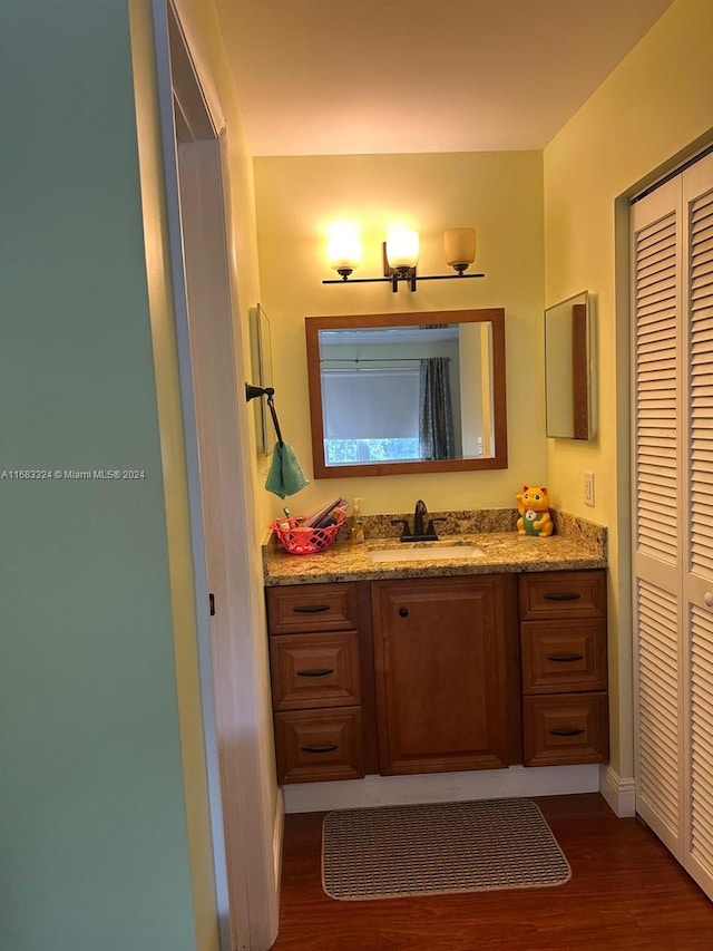 bathroom with vanity and hardwood / wood-style floors