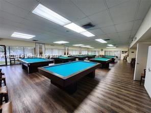 game room featuring pool table, dark hardwood / wood-style floors, and a paneled ceiling