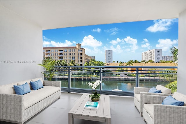 balcony with a water view and an outdoor hangout area