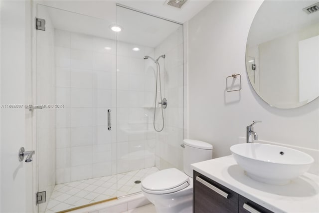 bathroom with vanity, toilet, and an enclosed shower