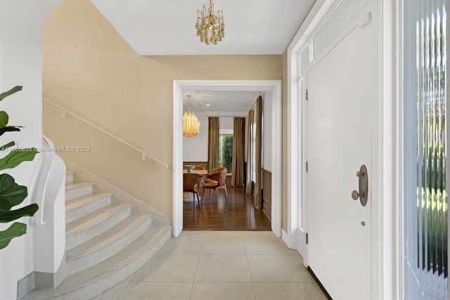 entrance foyer featuring light tile patterned floors and a chandelier