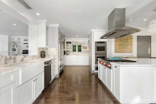 kitchen featuring island range hood, a center island, white cabinetry, appliances with stainless steel finishes, and dark hardwood / wood-style flooring