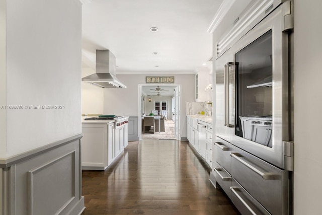 kitchen featuring extractor fan, stainless steel appliances, crown molding, white cabinets, and dark hardwood / wood-style flooring