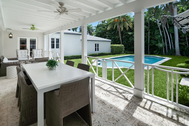 view of swimming pool with a patio, a yard, and ceiling fan