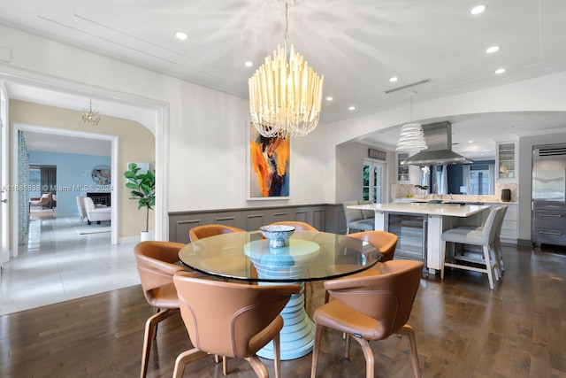 dining space featuring ornamental molding, dark hardwood / wood-style flooring, and beverage cooler