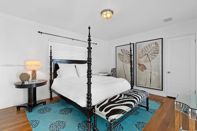 bedroom featuring hardwood / wood-style flooring and ornamental molding