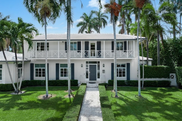 view of front of property with a front lawn and a balcony