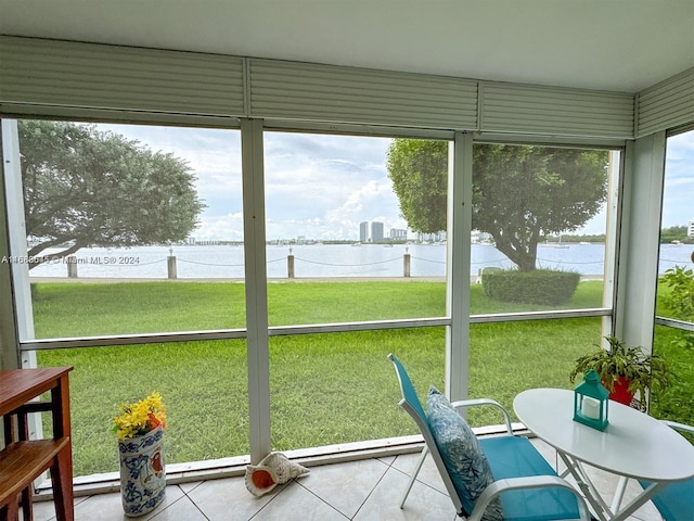 sunroom / solarium with a water view and a healthy amount of sunlight