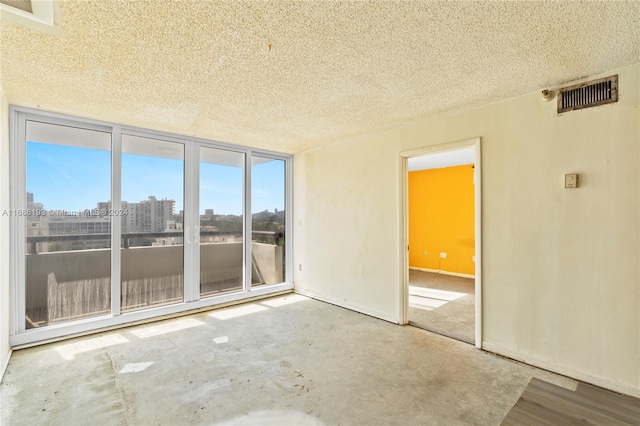 empty room featuring concrete flooring and a textured ceiling