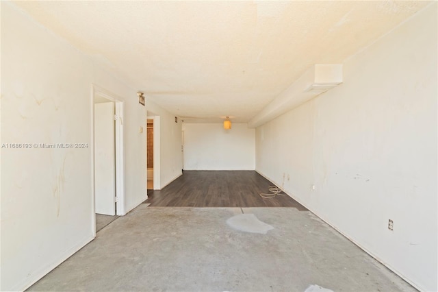 corridor with hardwood / wood-style flooring