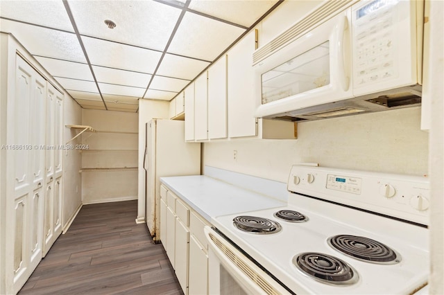 kitchen with dark hardwood / wood-style flooring, a paneled ceiling, white appliances, and white cabinets