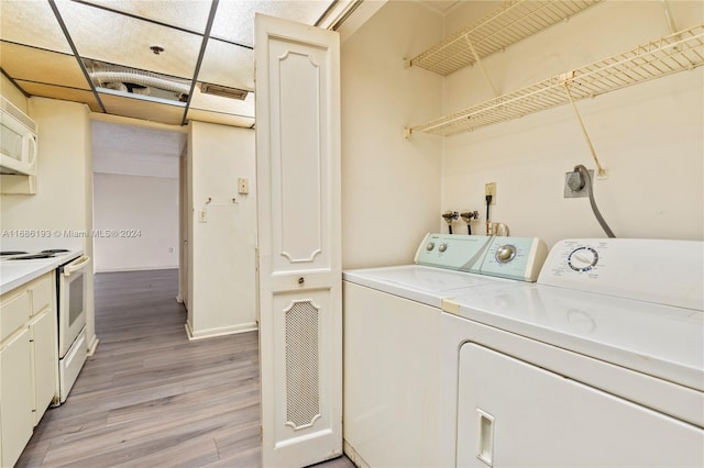 washroom featuring light wood-type flooring and washer and clothes dryer