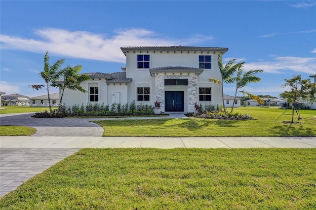 mediterranean / spanish house with a front yard