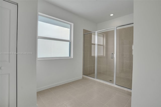 bathroom with walk in shower and tile patterned flooring