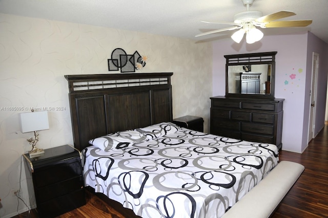 bedroom with a textured ceiling, dark hardwood / wood-style floors, and ceiling fan