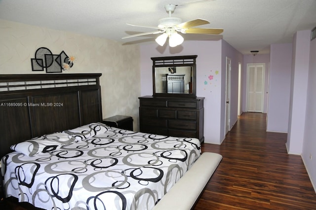 bedroom featuring dark hardwood / wood-style floors, a textured ceiling, and ceiling fan