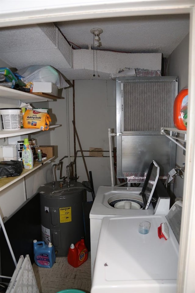 washroom featuring washer and clothes dryer and electric water heater