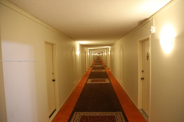 hallway with a textured ceiling