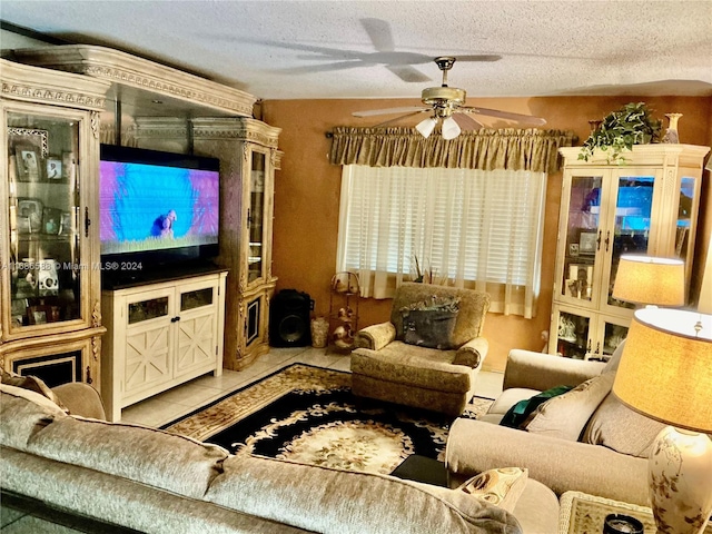 living room with vaulted ceiling, ceiling fan, light tile patterned flooring, and a textured ceiling