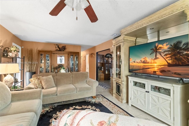 living room with light tile patterned floors, a textured ceiling, and ceiling fan