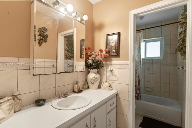 bathroom with shower / bath combo, vanity, and tile walls