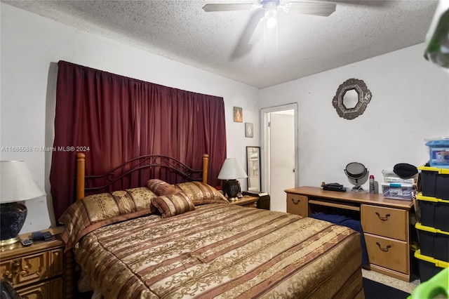 carpeted bedroom with ceiling fan and a textured ceiling