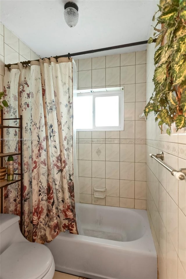 bathroom with shower / bath combo and toilet