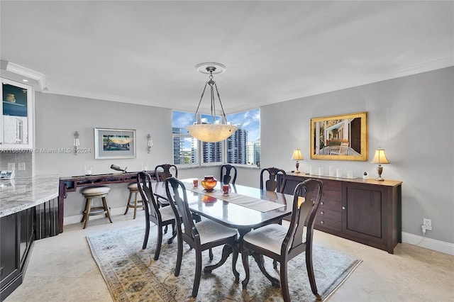 tiled dining area featuring ornamental molding