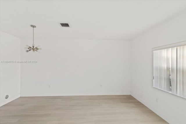 unfurnished room with light wood-type flooring