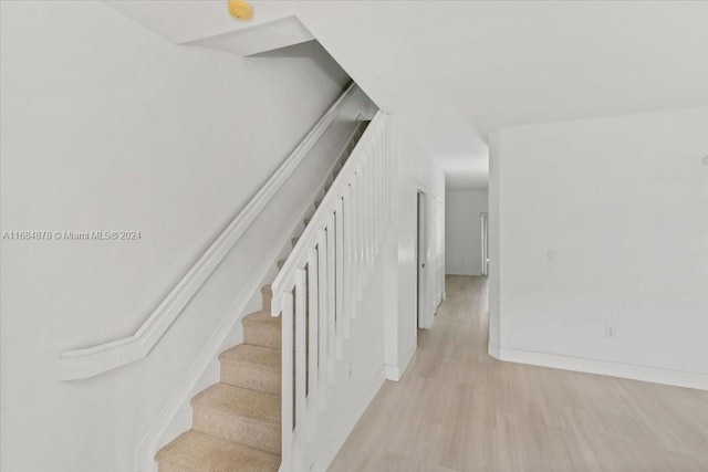 stairs with hardwood / wood-style floors