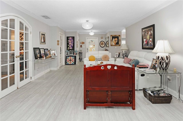 living room featuring french doors, ornamental molding, and light wood-type flooring