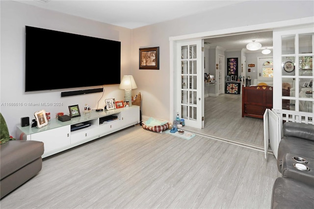 living room with light hardwood / wood-style flooring and crown molding