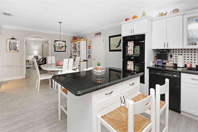 kitchen featuring white cabinetry, black appliances, ornamental molding, and decorative backsplash