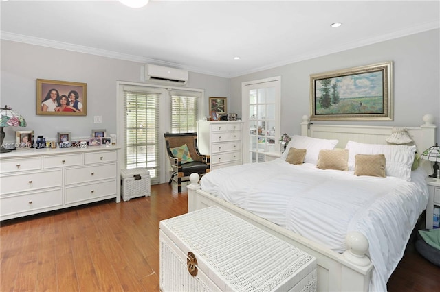 bedroom with a wall unit AC, hardwood / wood-style flooring, and crown molding